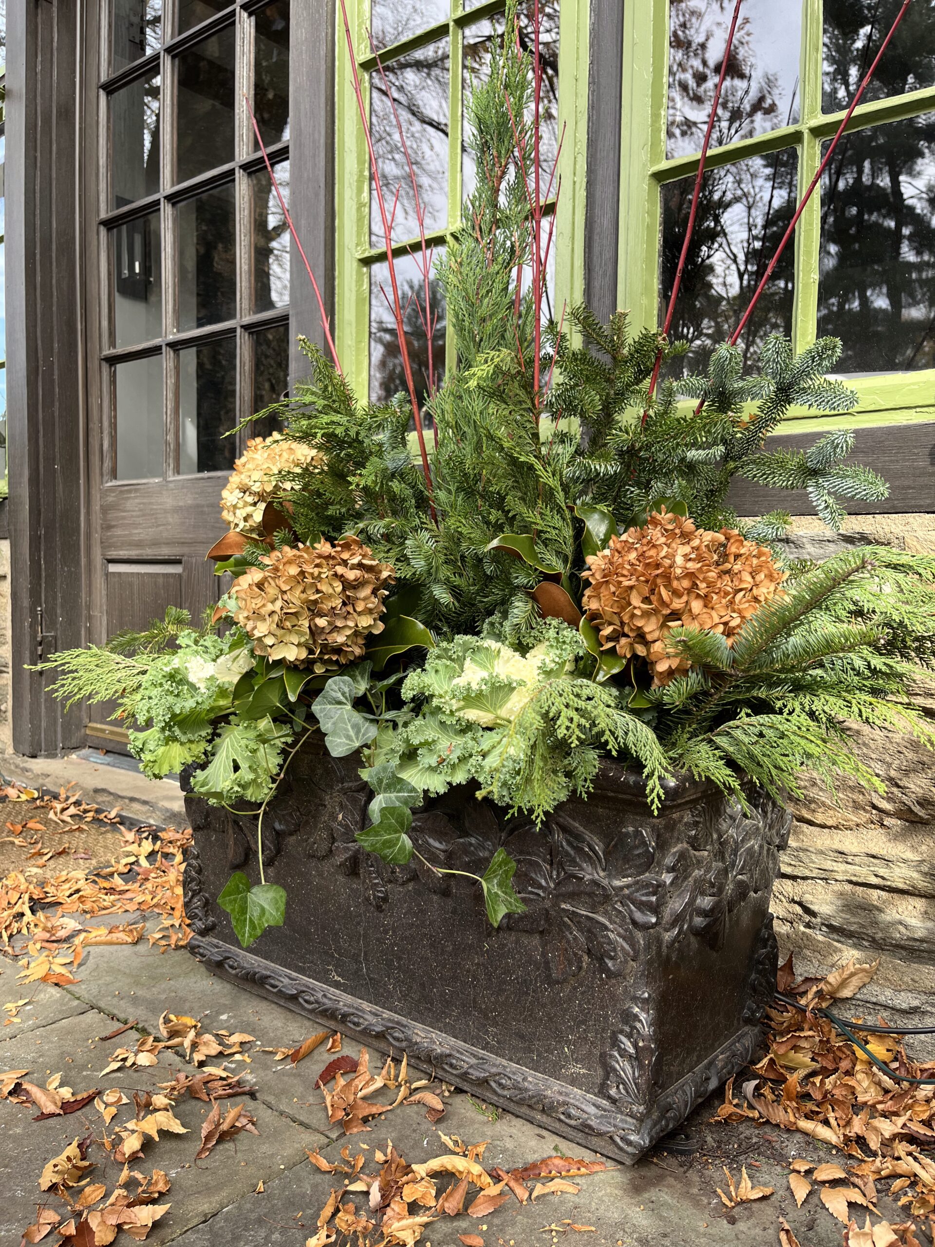 Rustic outdoor planter with hydrangeas and greenery