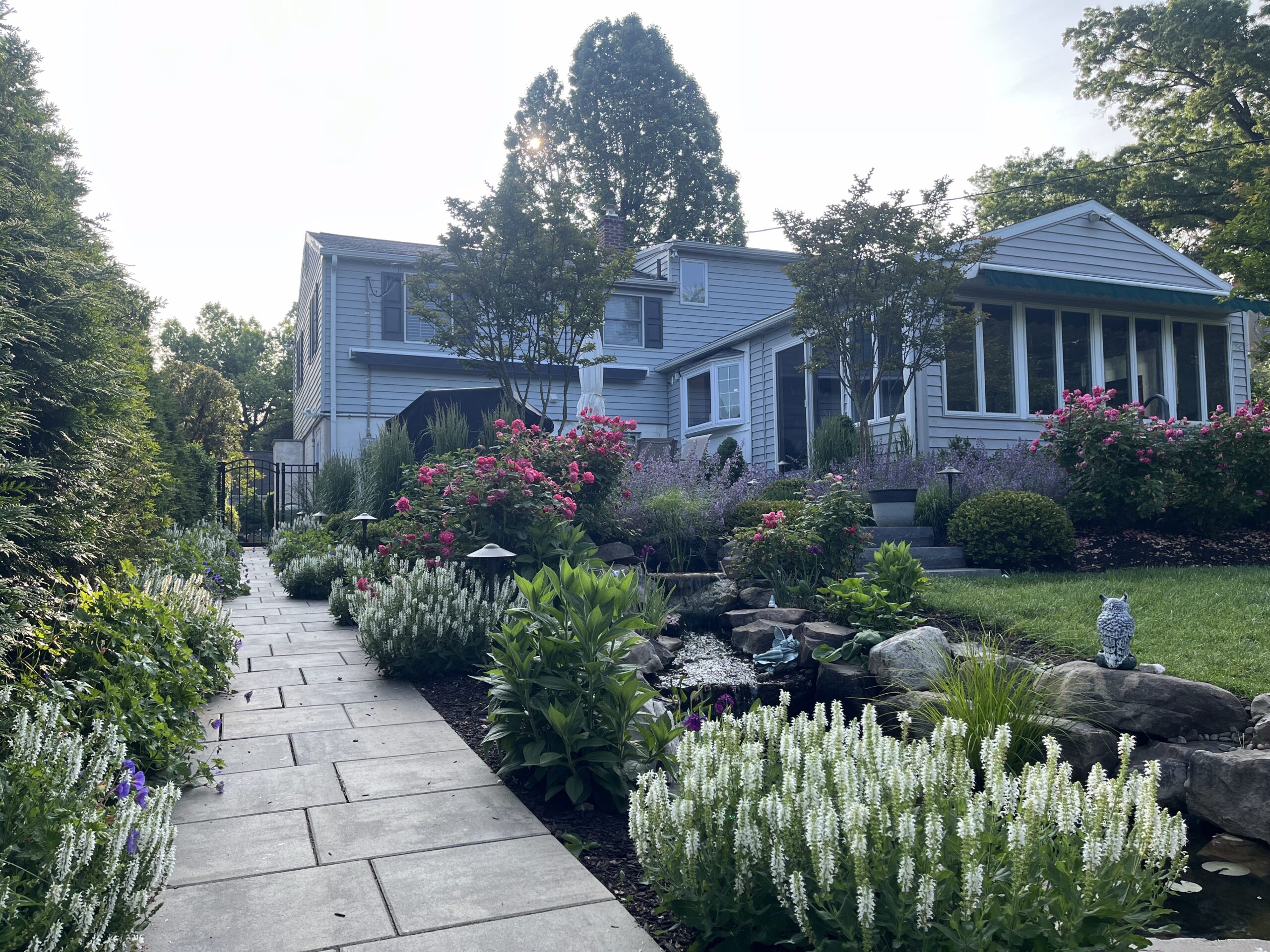 Charming garden path leading to a suburban house.