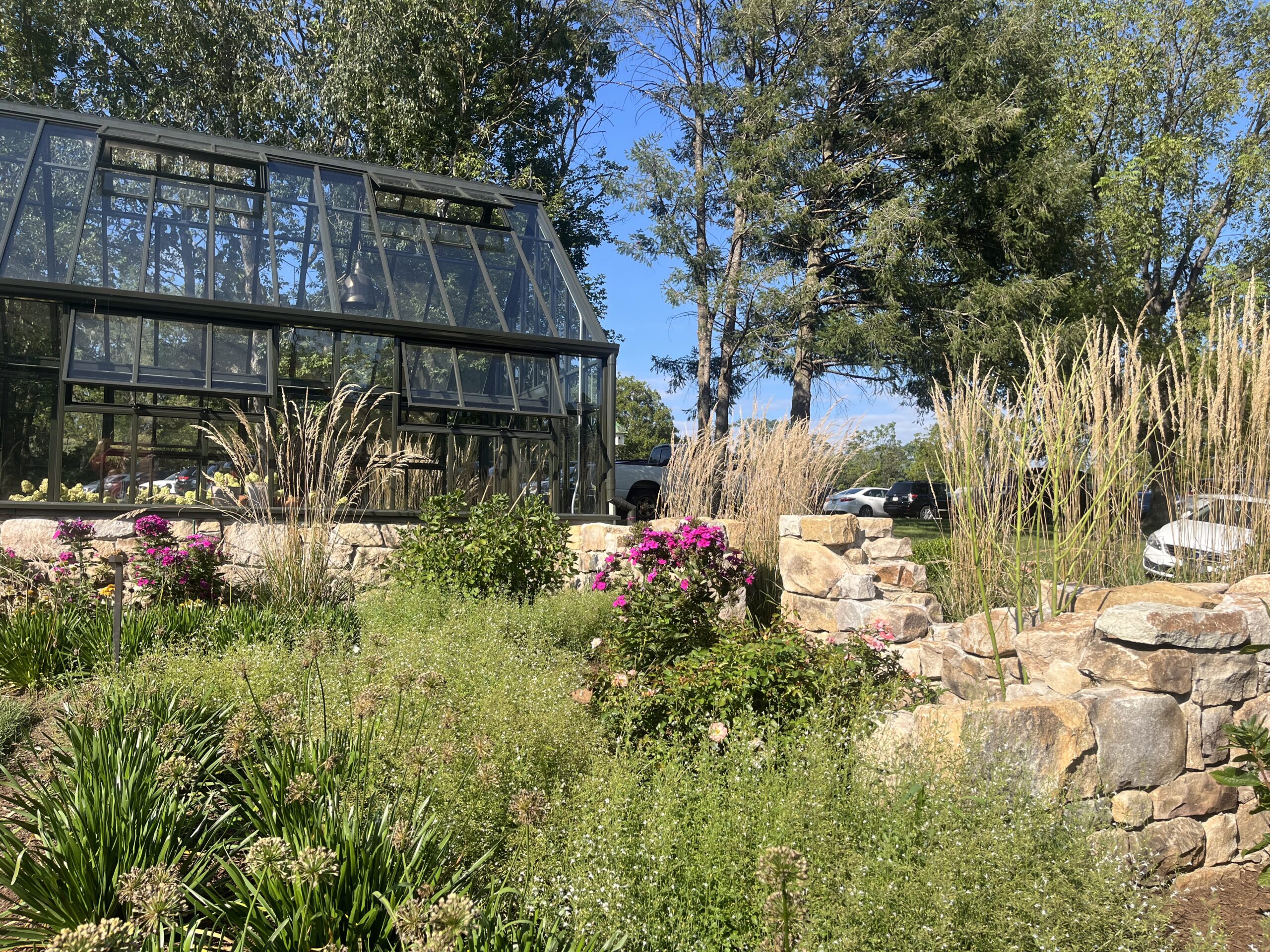 Greenhouse with garden and stone walls