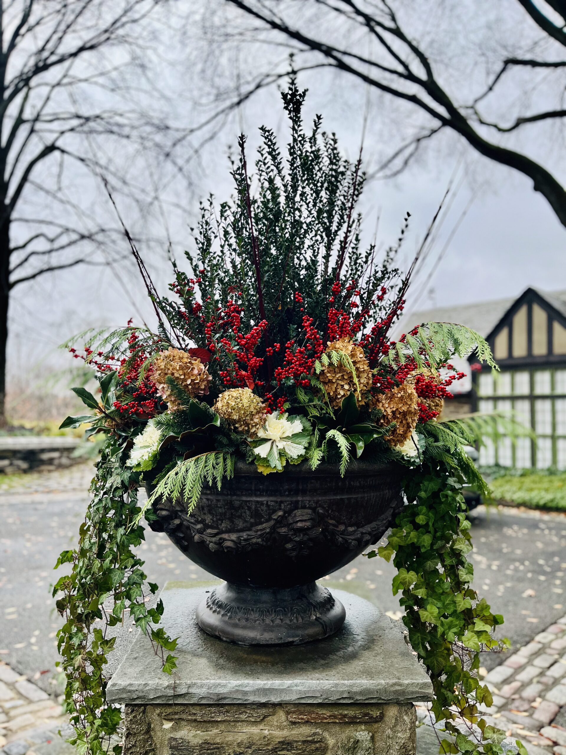 Decorative winter urn with red berries and greenery