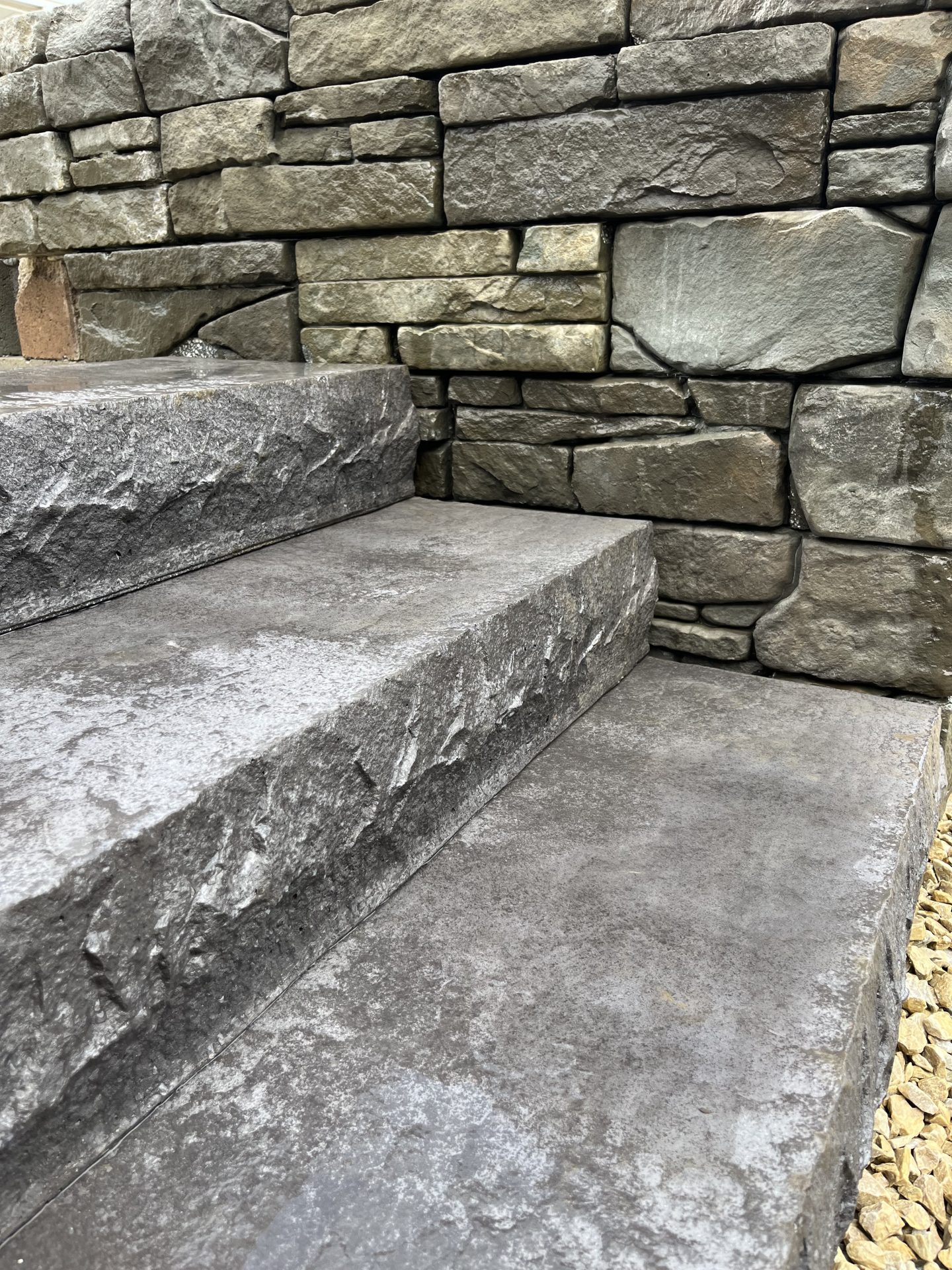 Stone steps with brick wall background.