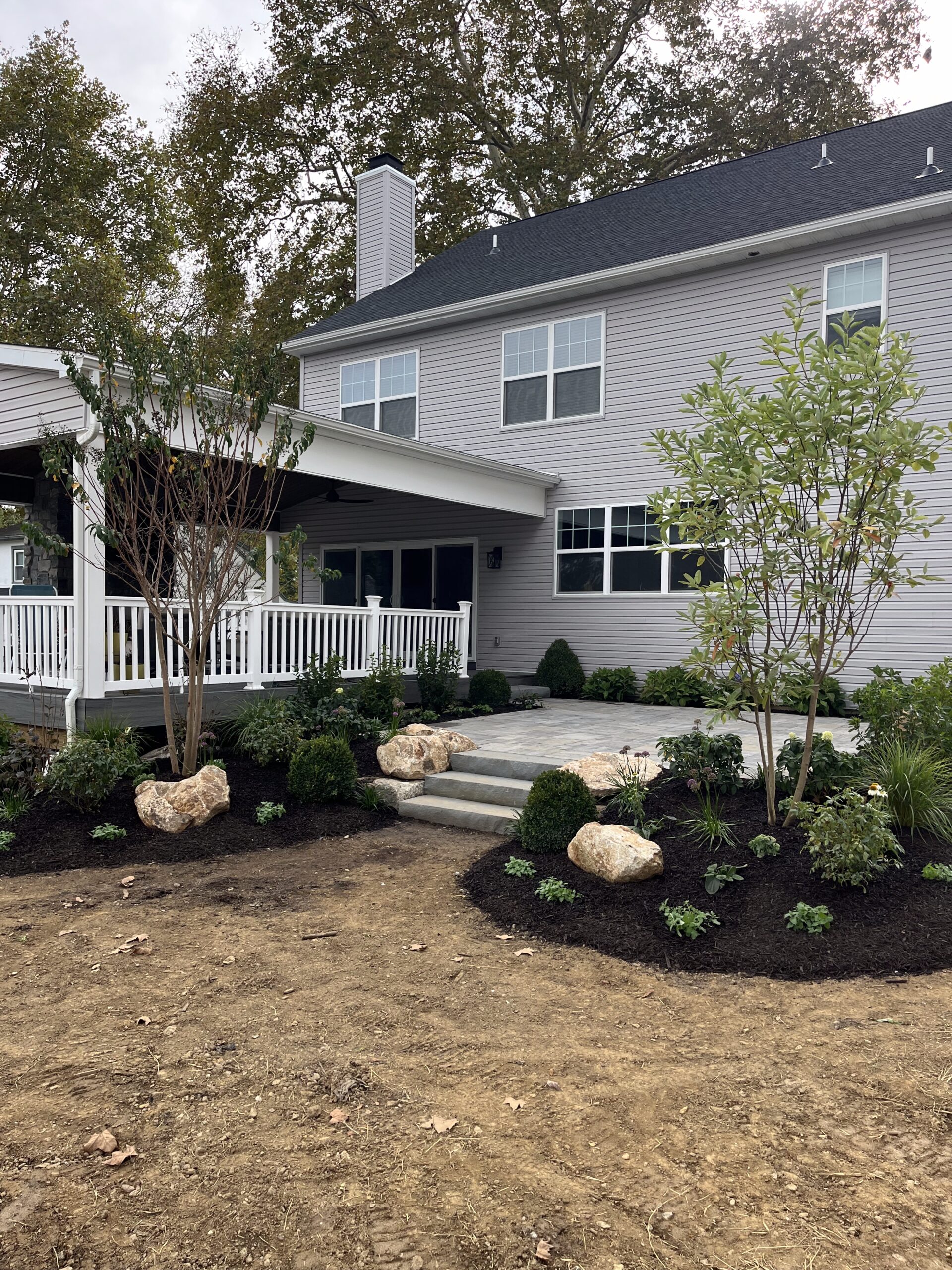 Suburban house with landscaped garden and porch.