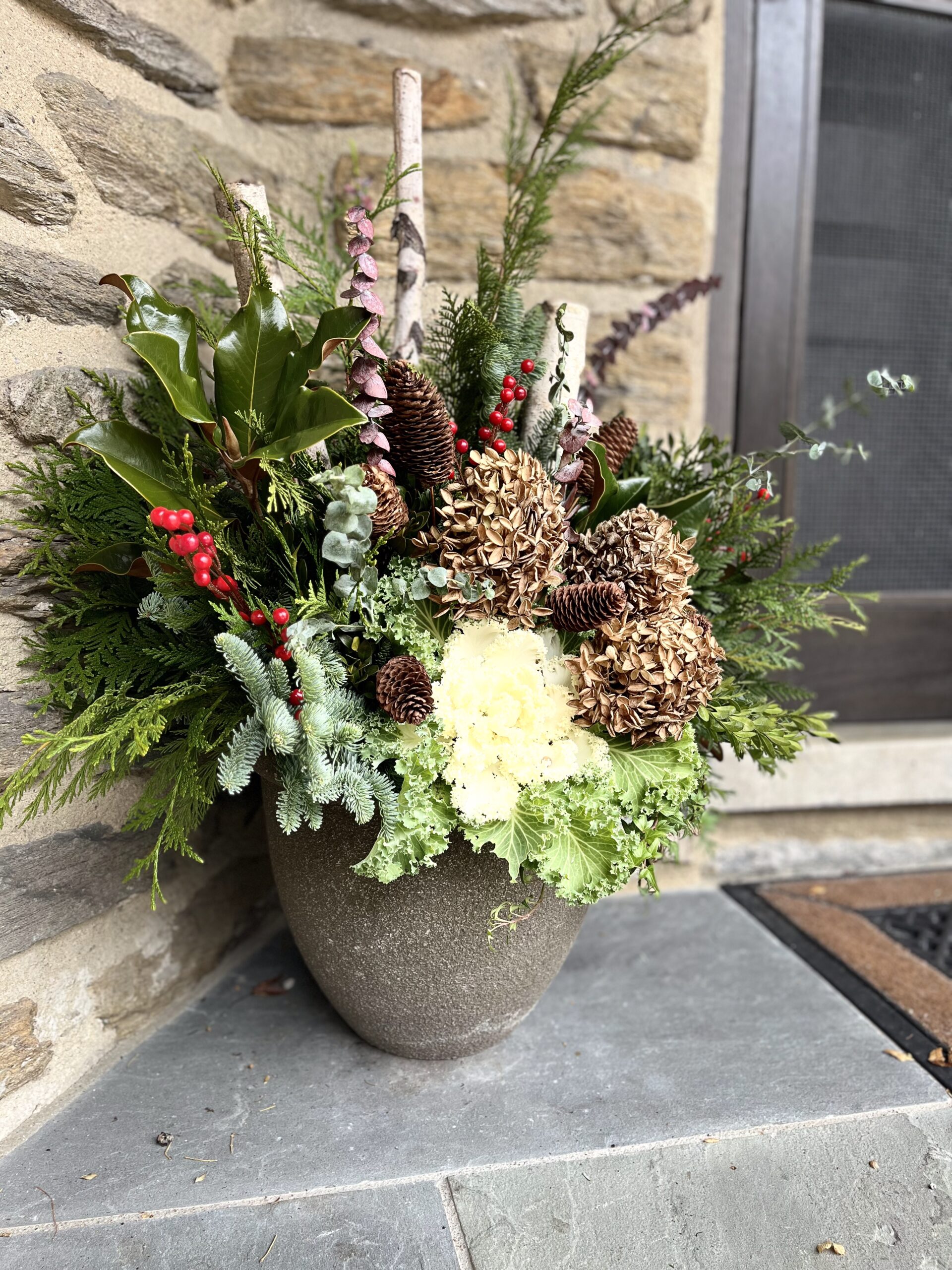 Festive winter arrangement with pinecones and greenery