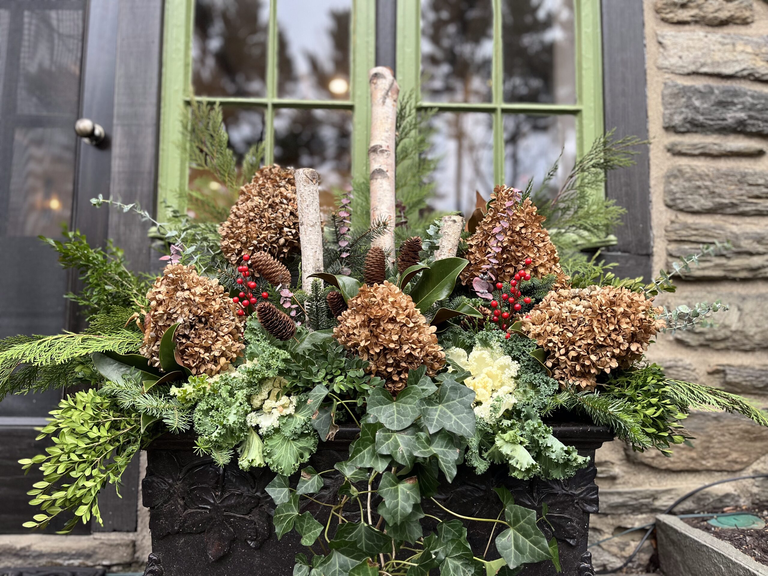 Rustic floral arrangement by green window