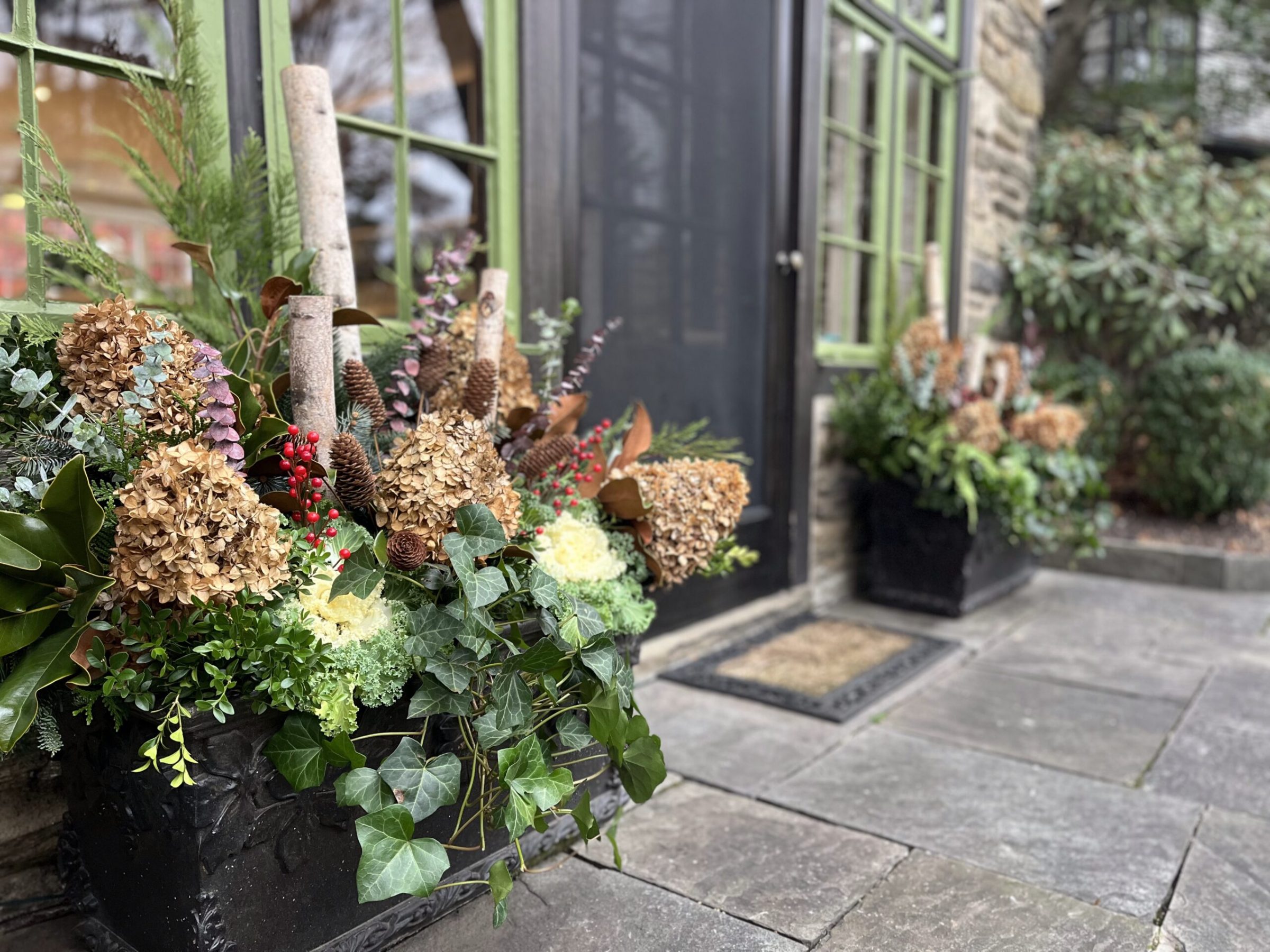 Outdoor planters with dried flowers and greenery